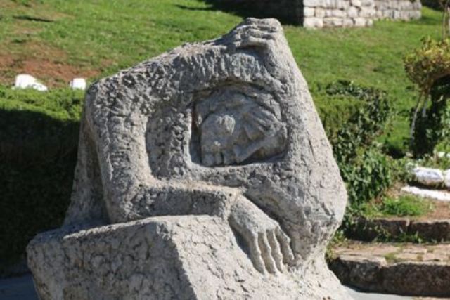 Kalavrita - 'Doleful Stony Mother' sculpture alongside the shrine 